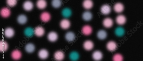Abstract blurred pink and teal circles on black background creating grainy bokeh effect for web design projects.