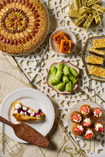 A beautiful flat lay food photography composition showcasing a rich assortment of traditional Middle Eastern desserts and oriental sweets,