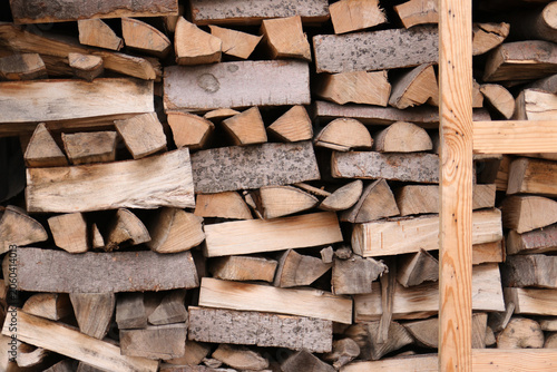 Stacked firewood logs stored in a wooden rack