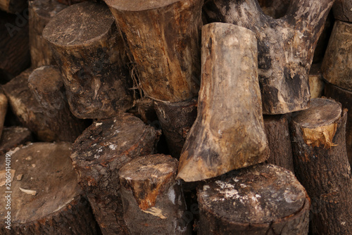 Chopped wooden logs stacked in rustic firewood pile