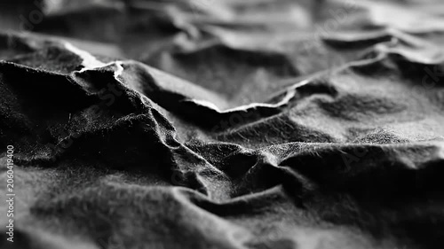 Dramatic black wrinkled fabric texture with deep shadows.