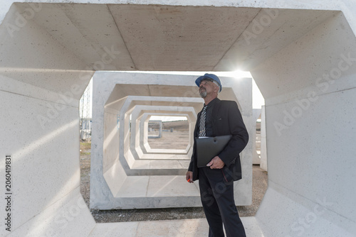 Industrial inspector checks the quality of the concrete structures and frames used for the construction of bridges and aqueducts