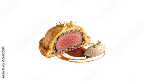 Gourmet Beef Wellington with golden puff pastry, medium rare beef tenderloin fillet, elegant fine dining plated meat dish with sauce isolated PNG with Transparent Background