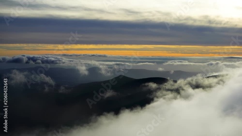 clouds floating across sunset hills horizon in Sudety mountains Poland