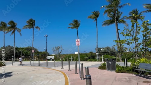 Tropical Beach entrance, drop off zone with security cameras and metal bollards