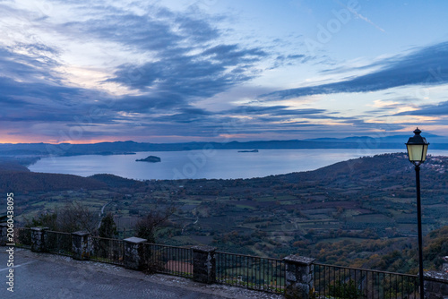 Obraz na plátně Panoramic sunset over Lake Bolsena from a scenic road, Italy
