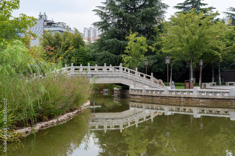 Fototapeta premium Marble bridge and pond near of museum garden of Xi'an museum on Youyi West Road, Beilin District, Xi'an, Shaanxi, China