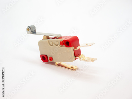 Micro switch with roller lever actuator on a white background