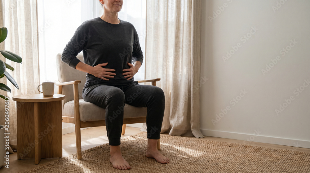 Fototapeta premium Seated home breathwork practice in modern living room with grounded posture