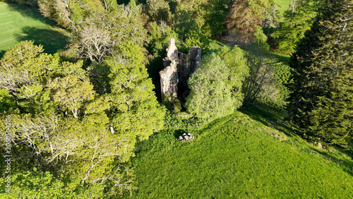 Valokuva From a sky-high distant perspective, Corse Castle in Scotland blends into vast landscapes, surrounded by fields and forests