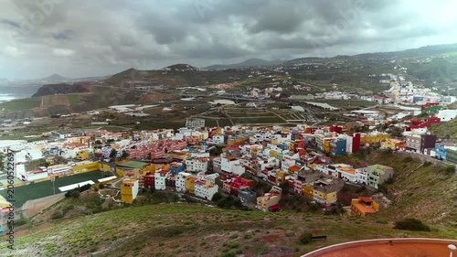 Pan across colorful houses on a mountain side, Galdar, Gran Canaria