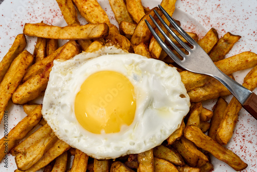 Fried egg and french fries on white plate