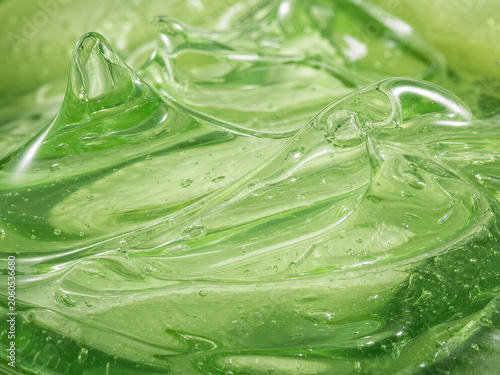 Green aloe vera gel texture, transparent cosmetic liquid with bubbles, moisturizing skincare product macro, organic beauty treatment background