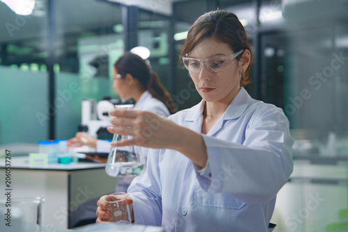 Scientist Conducting Chemical Experiment in Laboratory