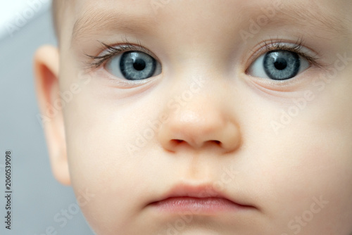 Obraz na płótnie Close-up of a toddler baby gazing at the camera with calm face