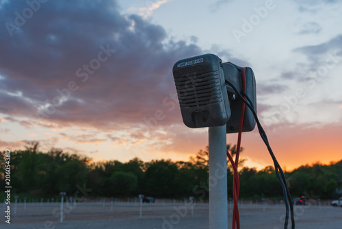 Drive-in theater speaker phone at sunset.