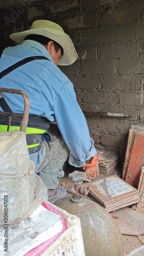 Construction Worker Moving Wall Tiles to Prepare Surface for Plastering