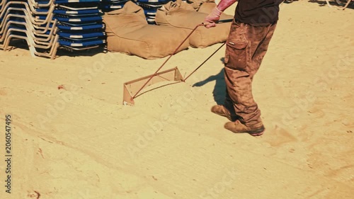 Hand Grader Sifting Sand On Greek Public Beach stock video