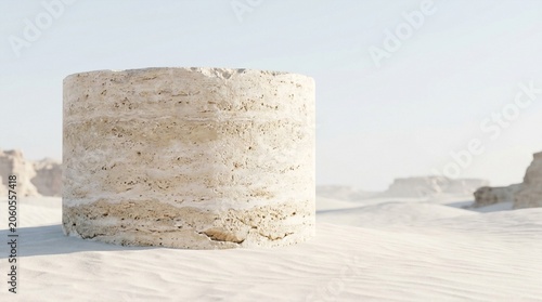 Cylindrical stone pedestal in a desert landscape with soft sunlight and distant rock formations