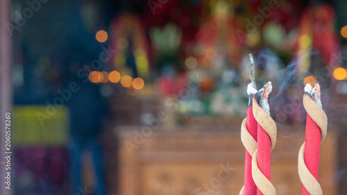 Bild auf Leinwand Burning Red Incense Jossi Sticks with Smoke in Buddhist Temple Altar