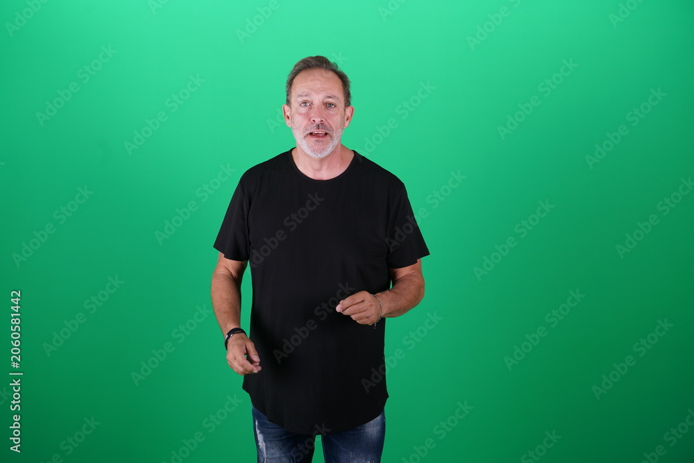 Fototapeta premium Real people. Man at his 50s, Medium shot, isolated on green screen in various poses and facial expressions. Studio capture with clean chroma key background, ideal for compositing