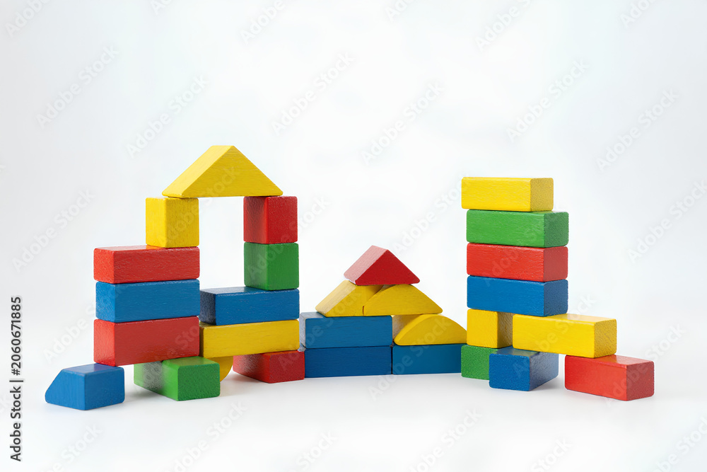 Fototapeta premium Bright multicolor building blocks stacked in playful arrangement, early childhood learning, creativity and motor skills concept, isolated on clean background