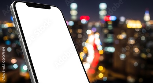 Modern smartphone with blank white screen against night cityscape bokeh lights