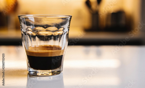 A fragrant espresso filled with freshly made rich foam in a glass