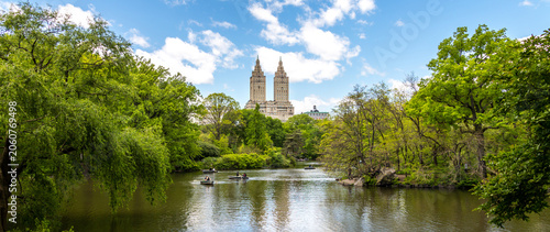 Row boats in lake in Central Park with Eldorado building in distance, Manhattan, New York city, USA