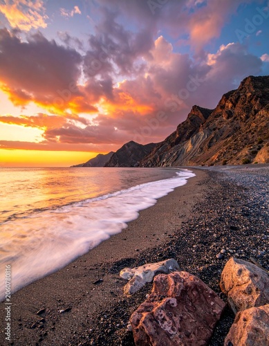 Coastal sunset over rocky beach