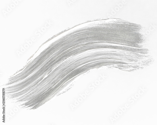 Swatch of white paint brushstroke on black background, showcasing texture