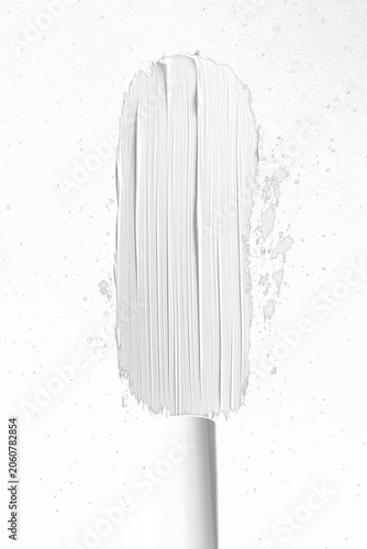 Brush tip revealing creamy white streaks against dark background