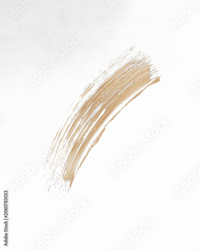 Beige makeup swatch against black background, highlighting texture and brushstrokes