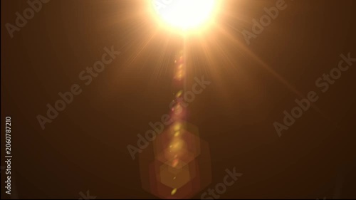Abstract bright light burst with optical lens flare,Bright explosion of fire and light in a starry night sky with a optical lens flare.