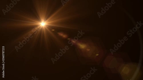 Abstract bright light burst with optical lens flare,Bright explosion of fire and light in a starry night sky with a optical lens flare.