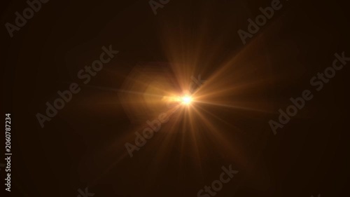 Abstract bright light burst with optical lens flare,Bright explosion of fire and light in a starry night sky with a optical lens flare.