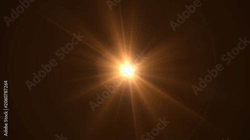 Abstract bright light burst with optical lens flare,Bright explosion of fire and light in a starry night sky with a optical lens flare.