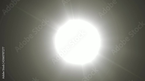 Abstract bright light burst with optical lens flare,Bright explosion of fire and light in a starry night sky with a optical lens flare.