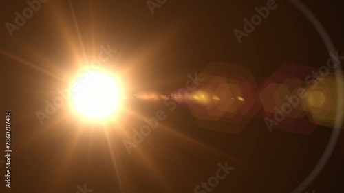 Abstract bright light burst with optical lens flare,Bright explosion of fire and light in a starry night sky with a optical lens flare.