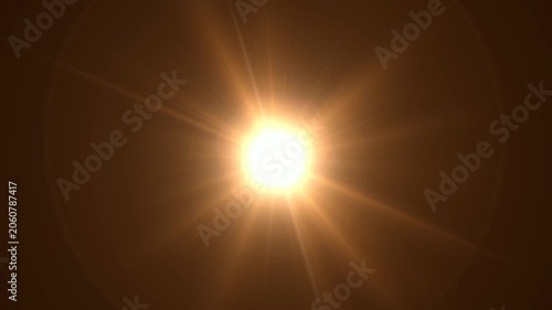 Abstract bright light burst with optical lens flare,Bright explosion of fire and light in a starry night sky with a optical lens flare.
