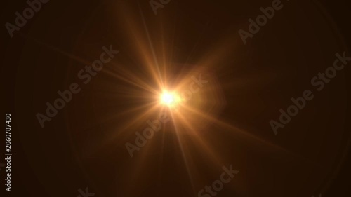 Abstract bright light burst with optical lens flare,Bright explosion of fire and light in a starry night sky with a optical lens flare.