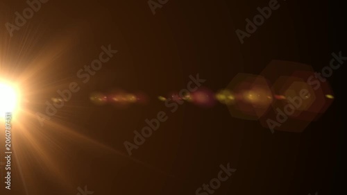 Abstract bright light burst with optical lens flare,Bright explosion of fire and light in a starry night sky with a optical lens flare.