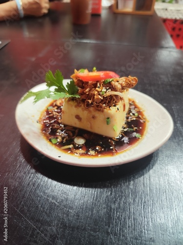Seasoned tofu, cut into cubes and topped with fried shallots and coriander, is a traditional local dish from Phuket Province, Thailand.