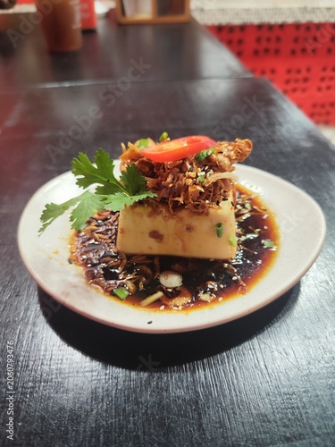 Seasoned tofu, cut into cubes and topped with fried shallots and coriander, is a traditional local dish from Phuket Province, Thailand.