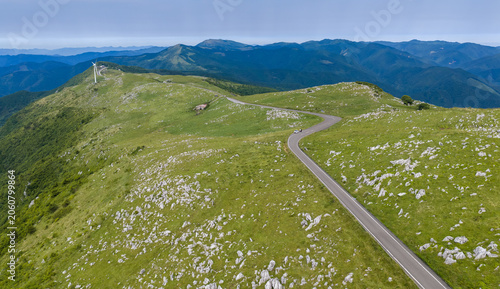 Fotografie Winding Ridge Road and Wind Turbine on the Open Shikoku Karst Plateau