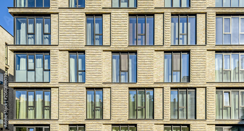 modern multifamily residential building with architectural details. exterior front view.