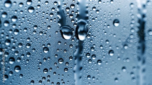 Transparent water droplets on glass surface background.