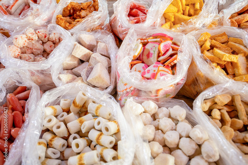 Photos Assorted fish cakes and processed seafood products at a traditional market in Ta