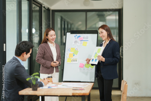 Professional Businesswoman Presenting Marketing Report and Charts to the Team