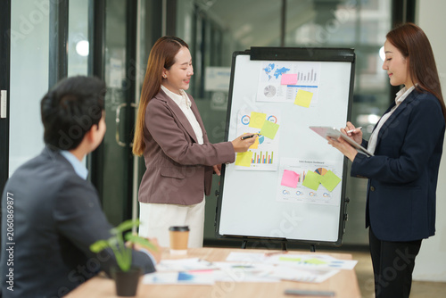 Professional Businesswoman Presenting Marketing Report and Charts to the Team